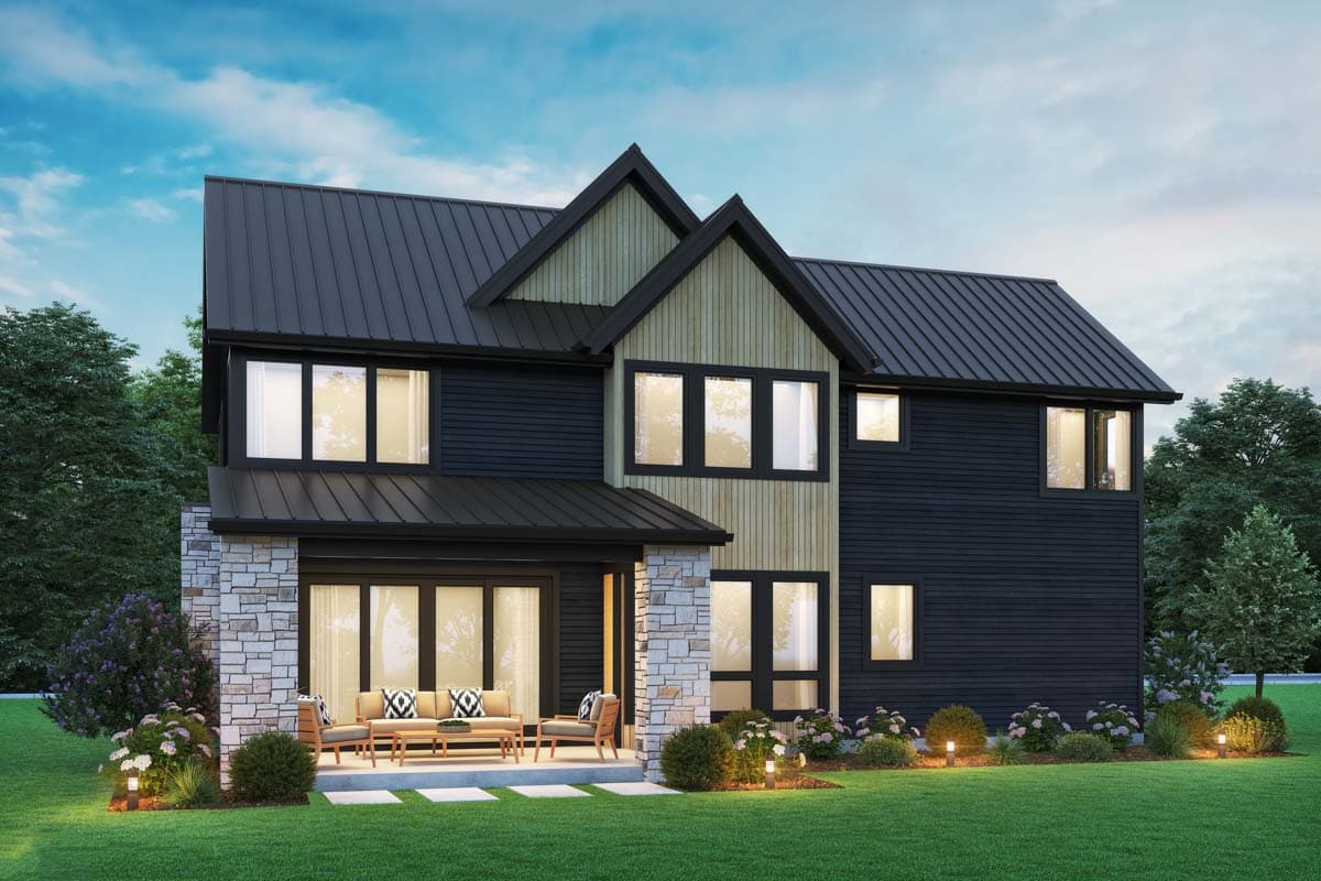 Two-story Modern Farmhouse exterior with stone foundation, dark horizontal siding, light wood accents, and a dark metal standing seam roof.