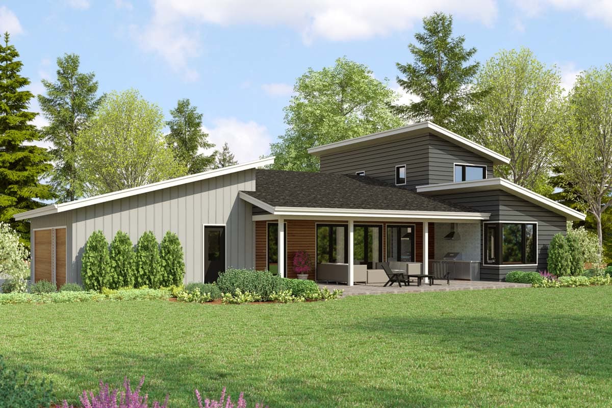 Modern house plan exterior with sloped rooflines, covered patio with outdoor kitchen, and multi-story sections.