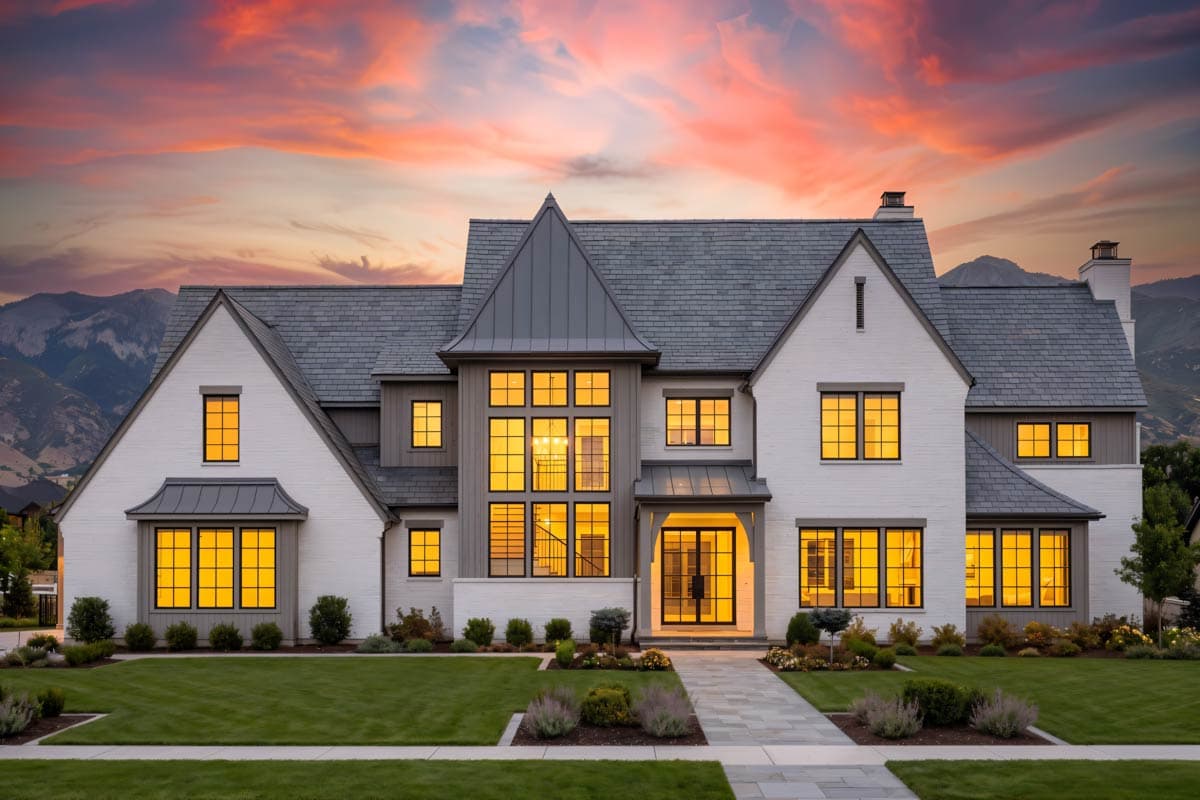 House plan exterior of a two-story home with multiple gables, a prominent central bay with large windows, and a covered entry.