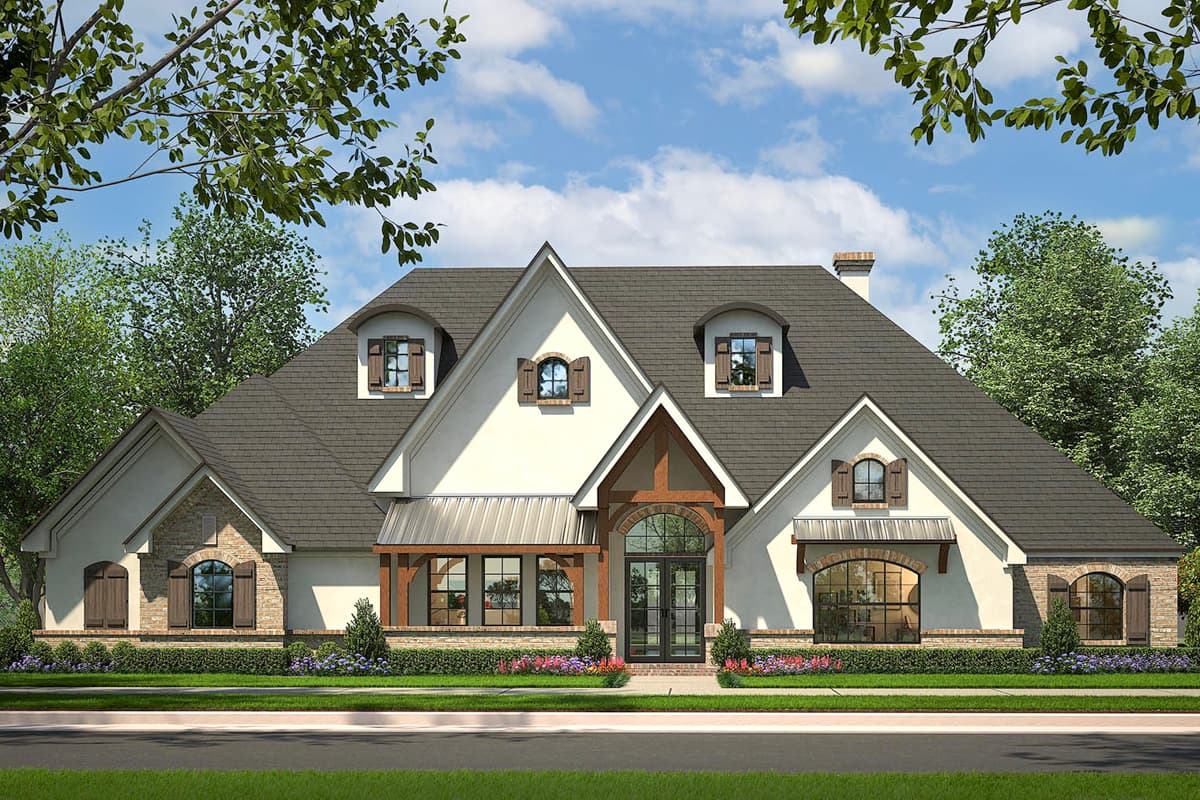 House plan exterior. Two-story home with a gabled roof, dormers, and a covered porch. Features brick and stucco exterior with multiple arched windows.