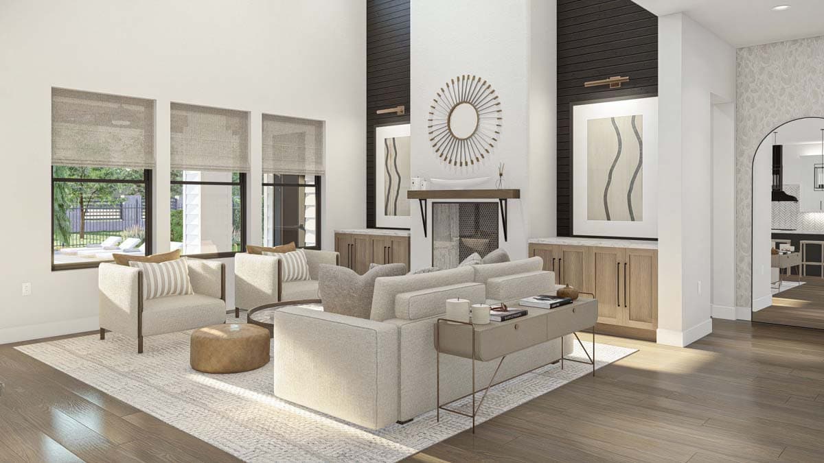 Great room with vaulted ceiling, fireplace with dark wood accent, and large windows overlooking a pool area.