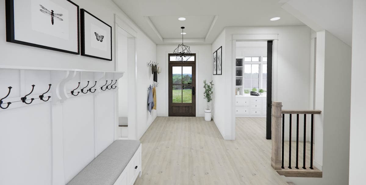 A bright, modern hallway features a wooden door leading outside, a white coat rack, and black framed artwork with insect and butterfly prints.
