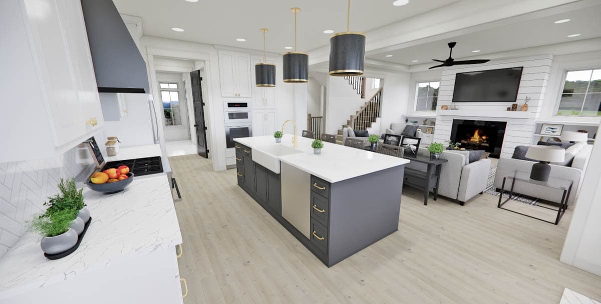A modern, open-concept kitchen and living area with a large island, pendant lights, and a fireplace with a mounted television.
