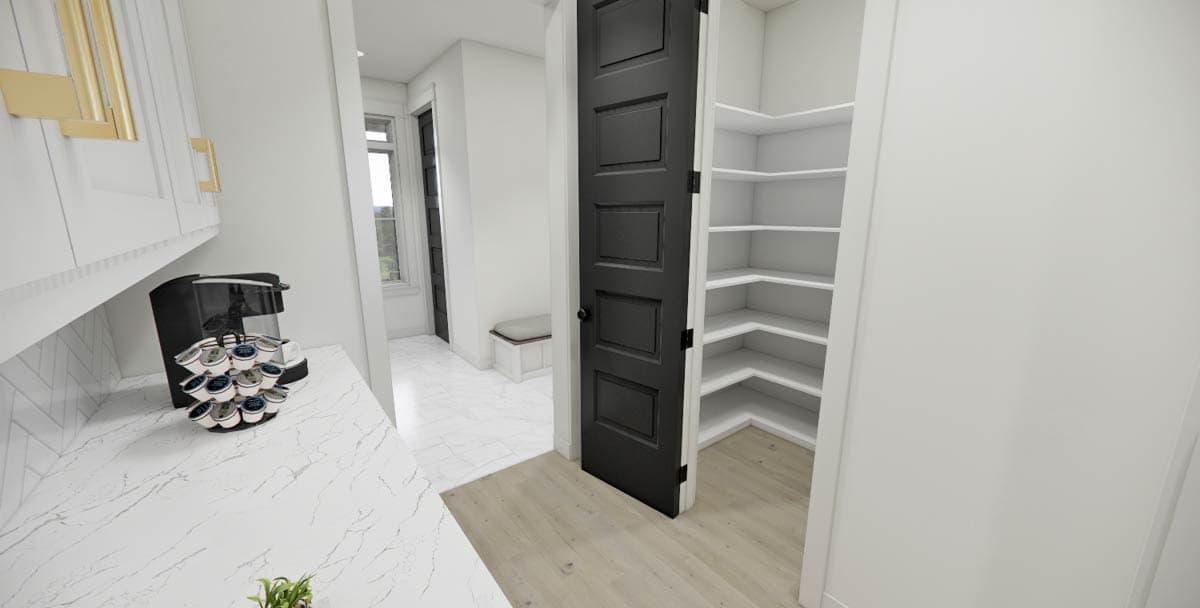 A modern kitchen with white cabinets, a black door opening to a pantry with white shelves, and a coffee maker on the counter.