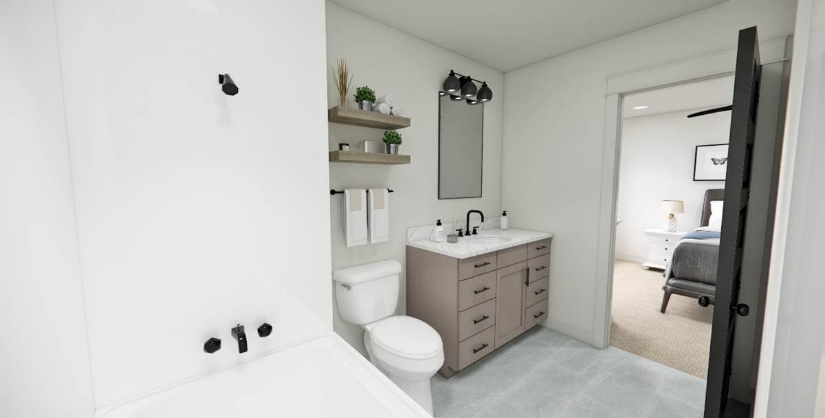A modern bathroom features a toilet, vanity, and shower area. The doorway reveals a glimpse of an adjacent bedroom, enhancing the space's flow.