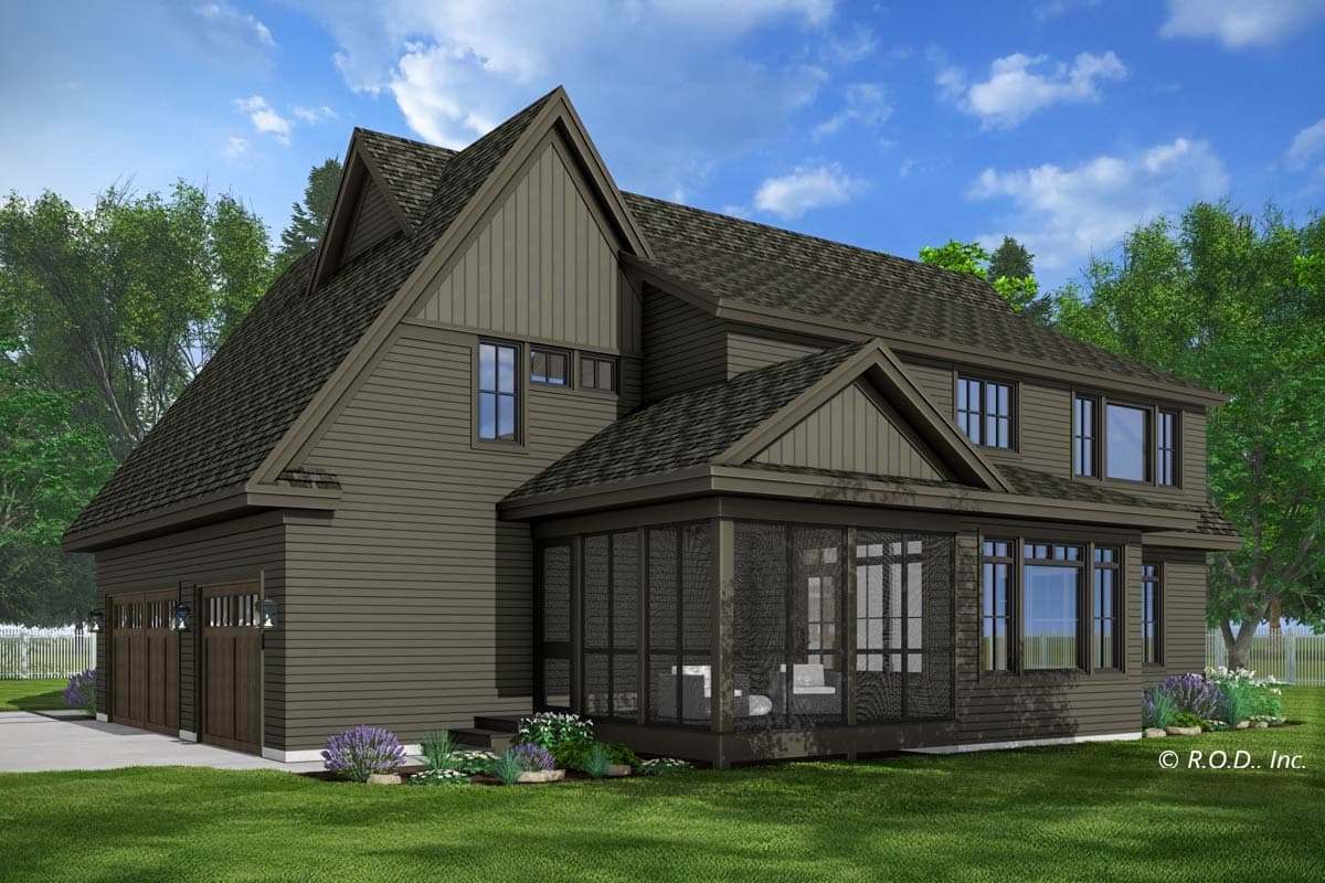 A two-story house with a screened porch and multiple gables. The exterior is a muted green-brown, with a manicured lawn and landscaping.