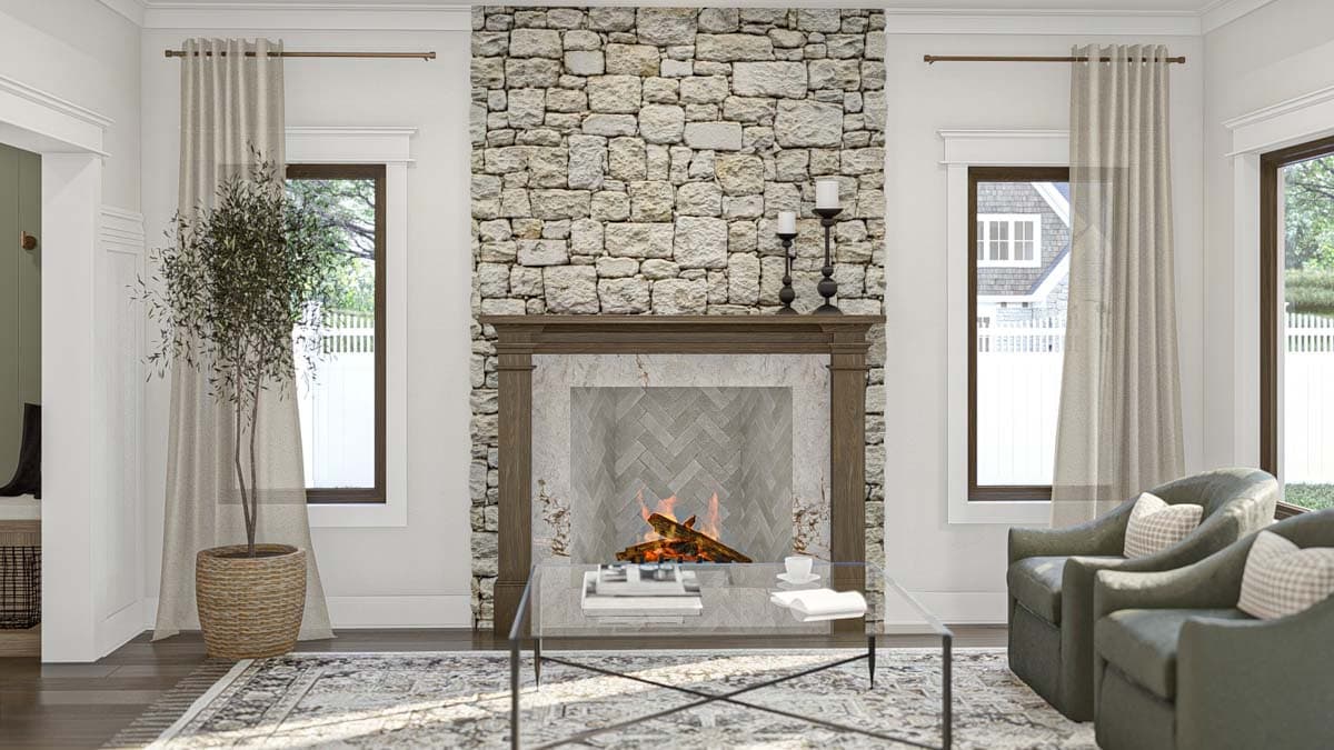 Living room featuring a stone fireplace, mantel, herringbone tile surround, glass coffee table, and seating.