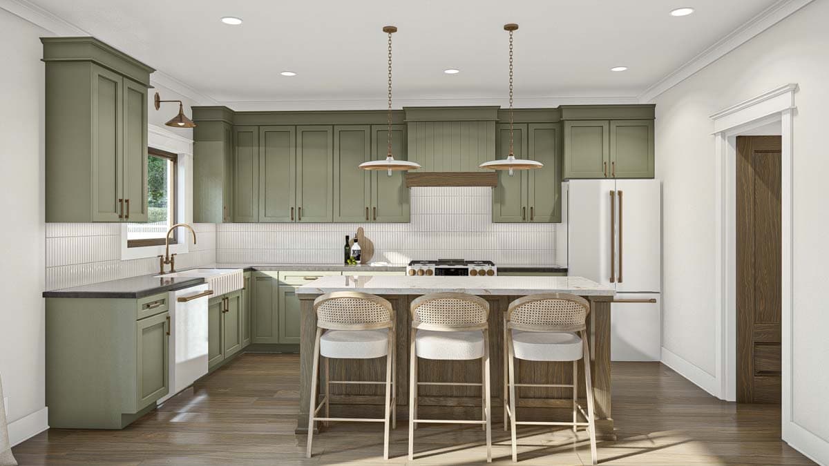 Kitchen interior with sage green cabinetry, white subway tile backsplash, and a central island with pendant lights and seating.