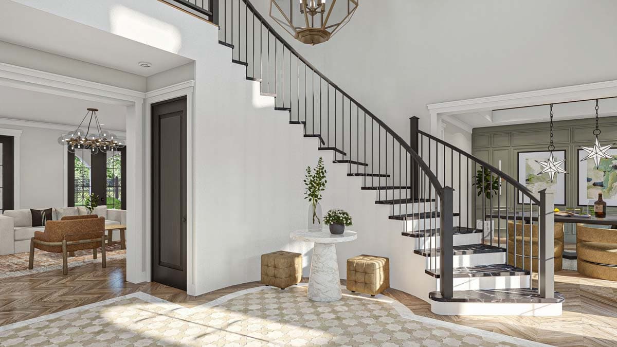 Interior view of a modern house entryway with a curved staircase, dark metal railings, marble treads, and decorative floor inlay.