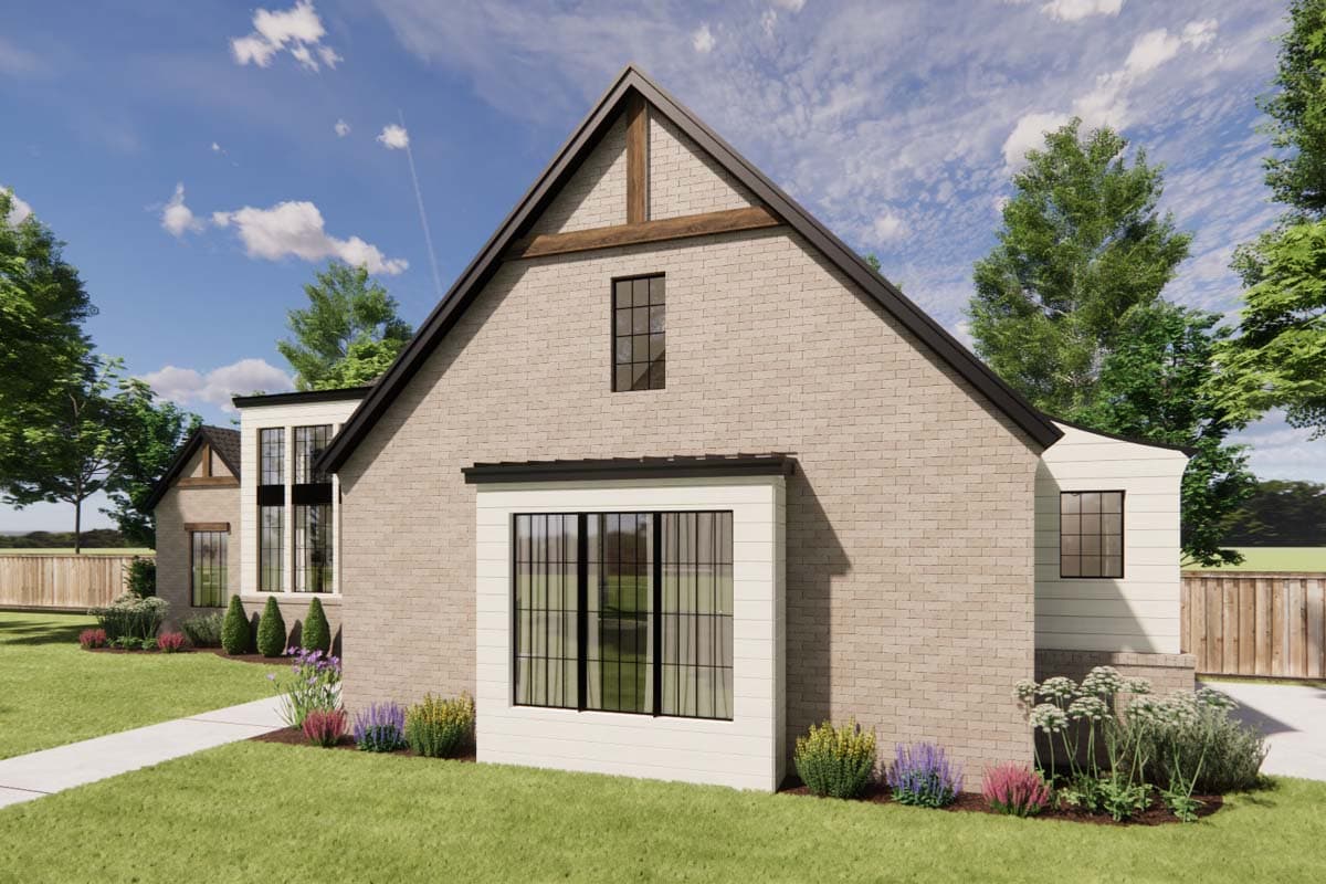 House plan exterior with brick facade, steep gables, prominent dormer, and large grid windows.