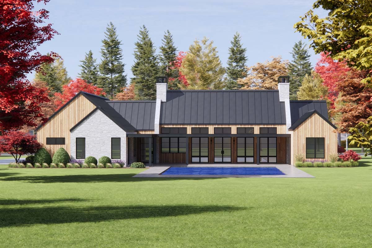 Modern house plan exterior with metal roof, stone and wood siding, gables, and large glass doors opening to a pool.