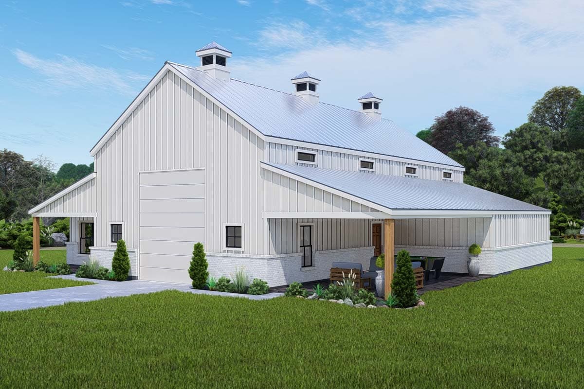 Barn style house plan exterior with a large garage door, gabled roof with cupolas, and covered patio.