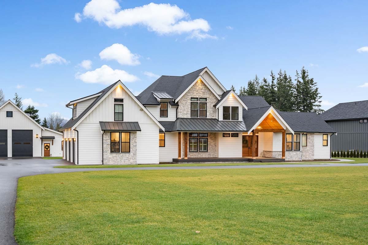 Modern Farmhouse house plan exterior with stone accents, multiple gables, and a covered entry. Attached garage.