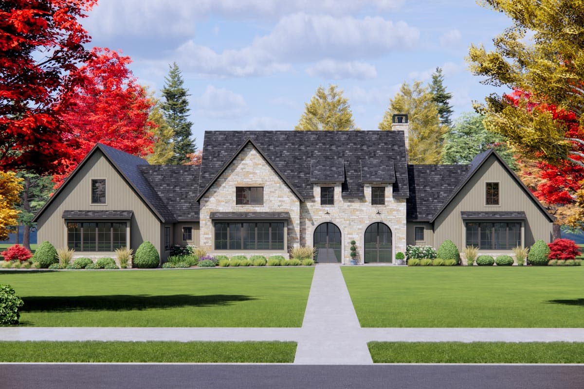 House plan exterior. Two-story house with stone facade and gabled roof. Features include arched entry and dormers. Landscaped front yard.