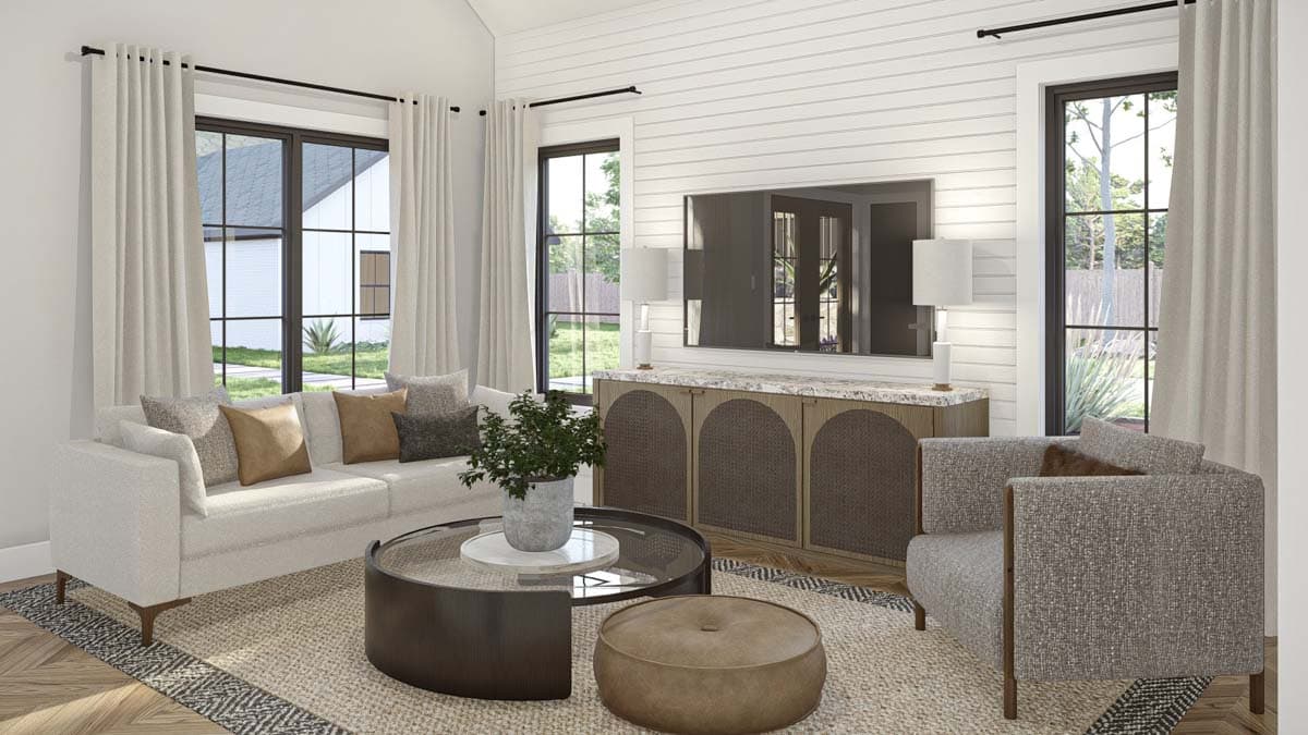Living room with fireplace, built-in cabinets, large windows, shiplap accent wall, and vaulted ceiling.