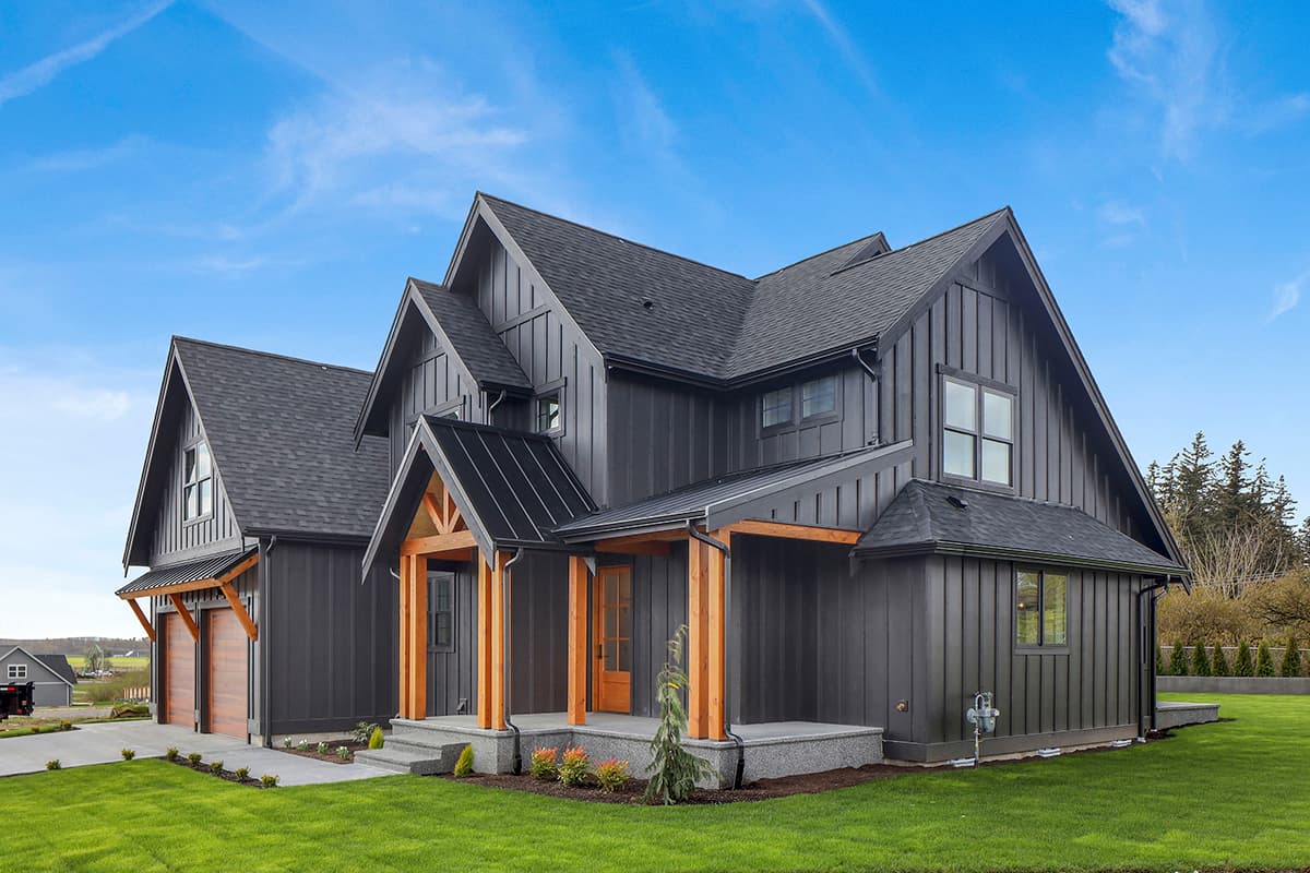 Modern Farmhouse house plan exterior with dark vertical siding, prominent gables, and exposed wooden beams on the porch.