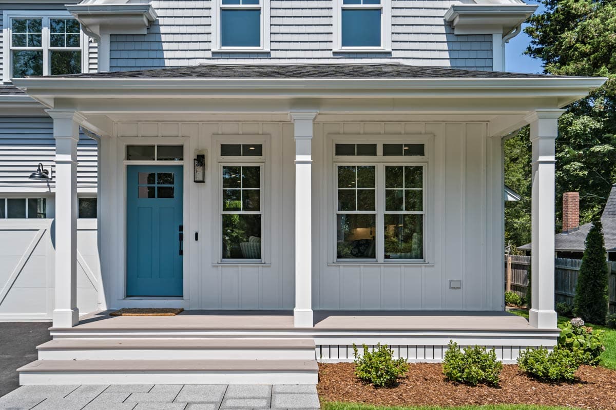 House plan exterior: Modern Farmhouse style, two stories, covered porch with columns, dormers, and siding.