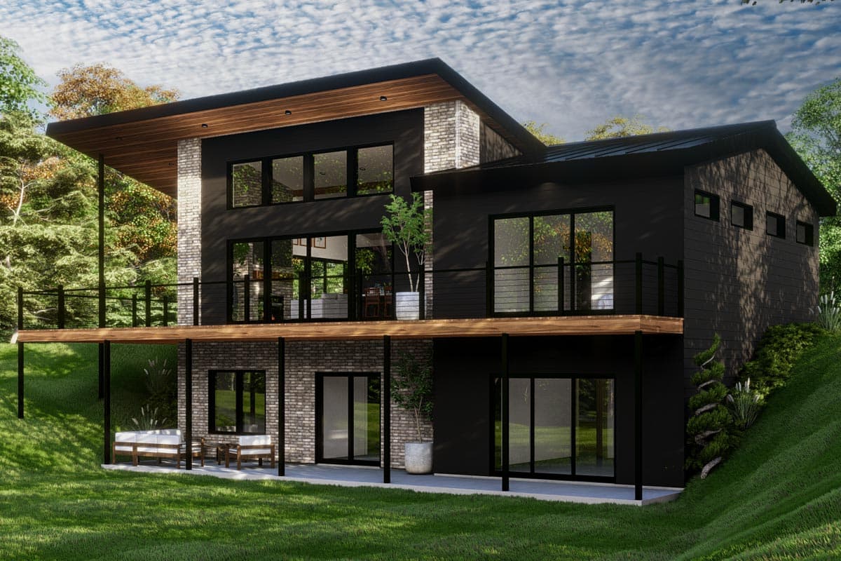 Modern house plan exterior: two stories, flat roof, large windows, balconies, and brick accents on a sloped lot.