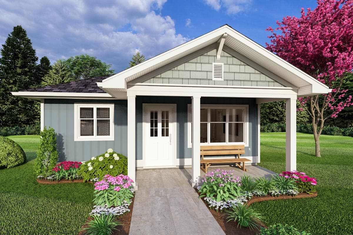 House plan exterior. Single-story cottage with front porch, gabled roof, and decorative gable vent. Features include a bench and window placement.