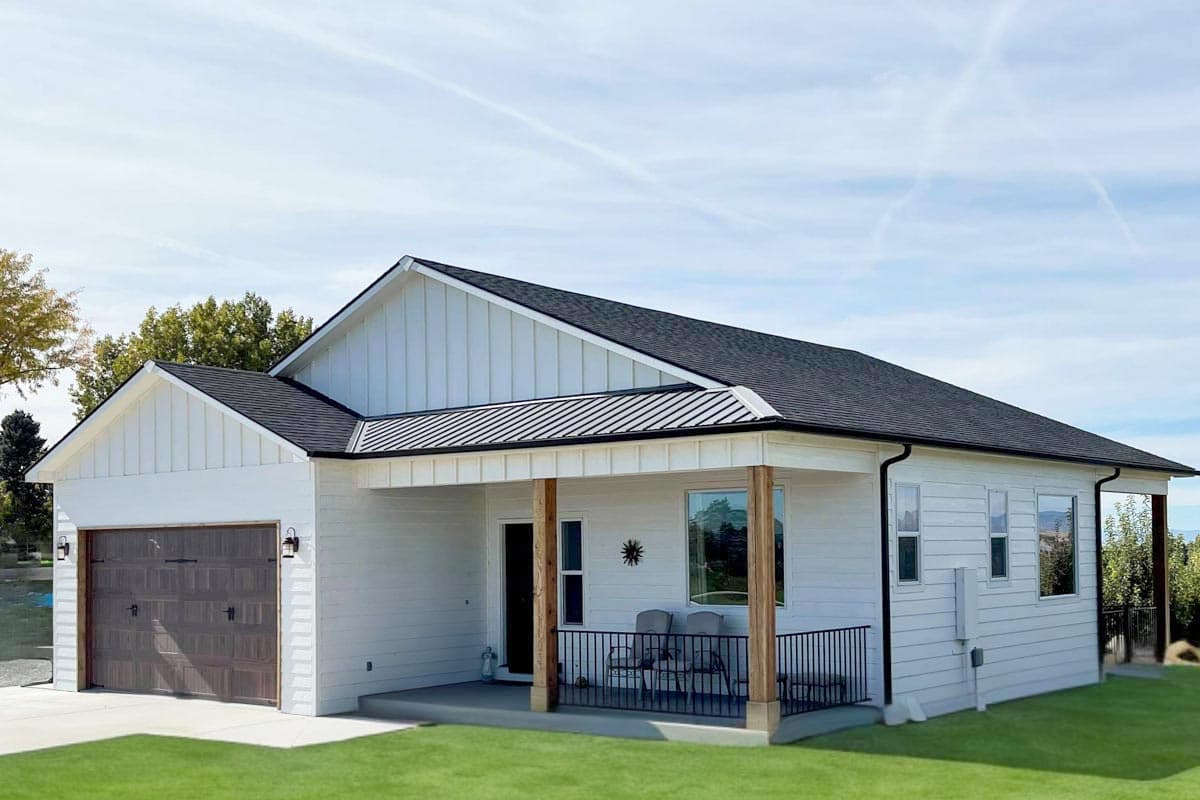 House plan exterior. Modern Farmhouse style with a single story, a covered porch, board and batten siding, and a gabled roof.