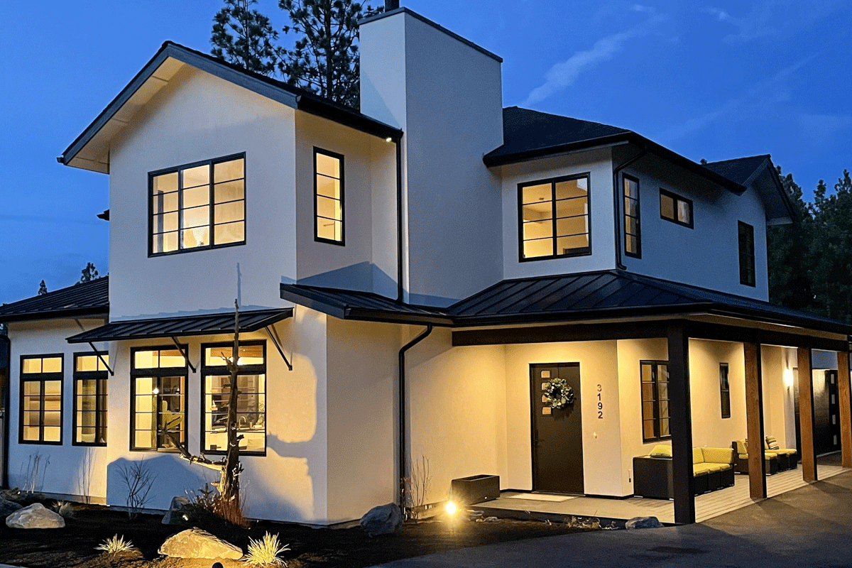 House plan exterior with modern style, two stories, black metal roof accents, and covered porch with supporting columns. Large windows are featured.