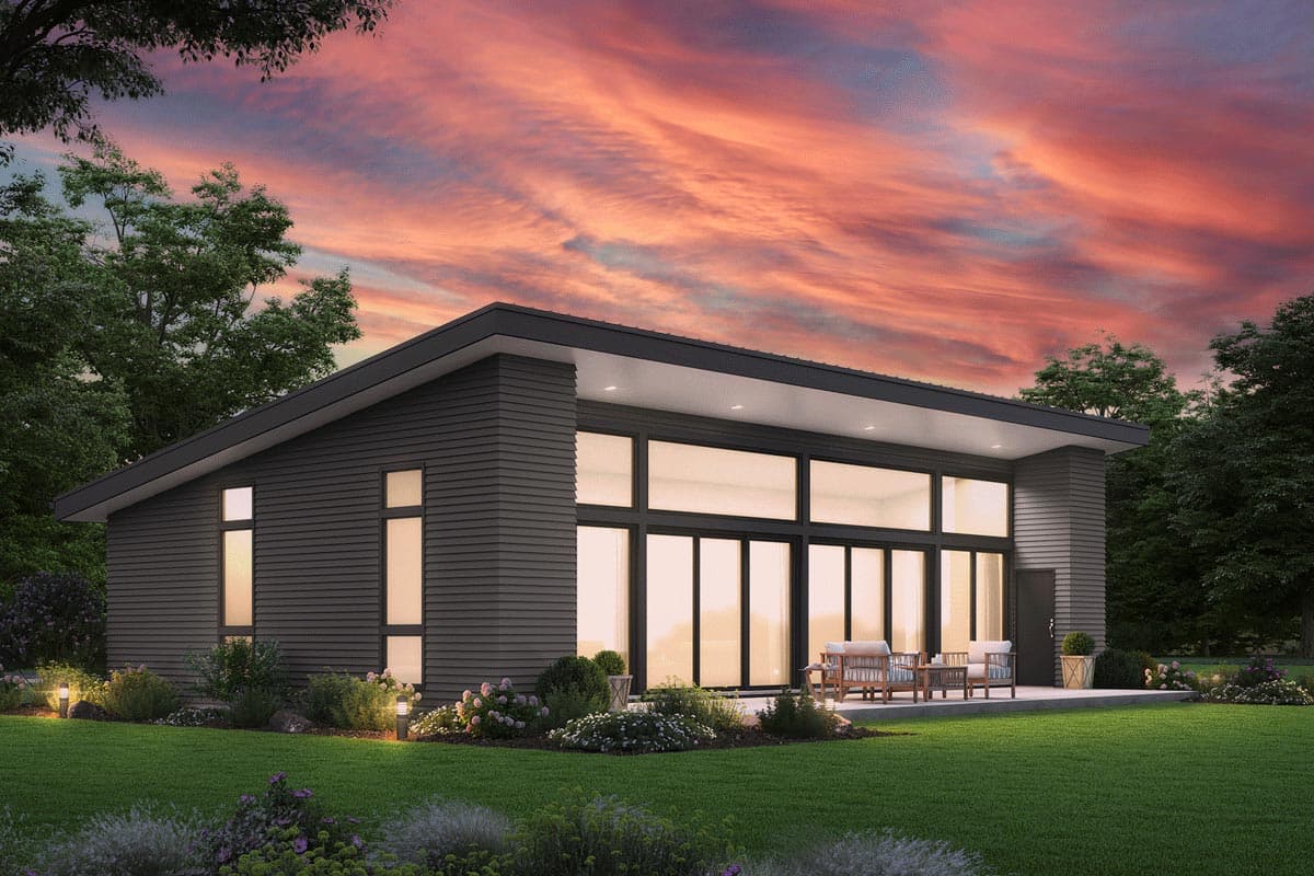House plan exterior. Modern style with a single story. Features include a flat roof, large windows, and a patio area. Siding is dark gray.