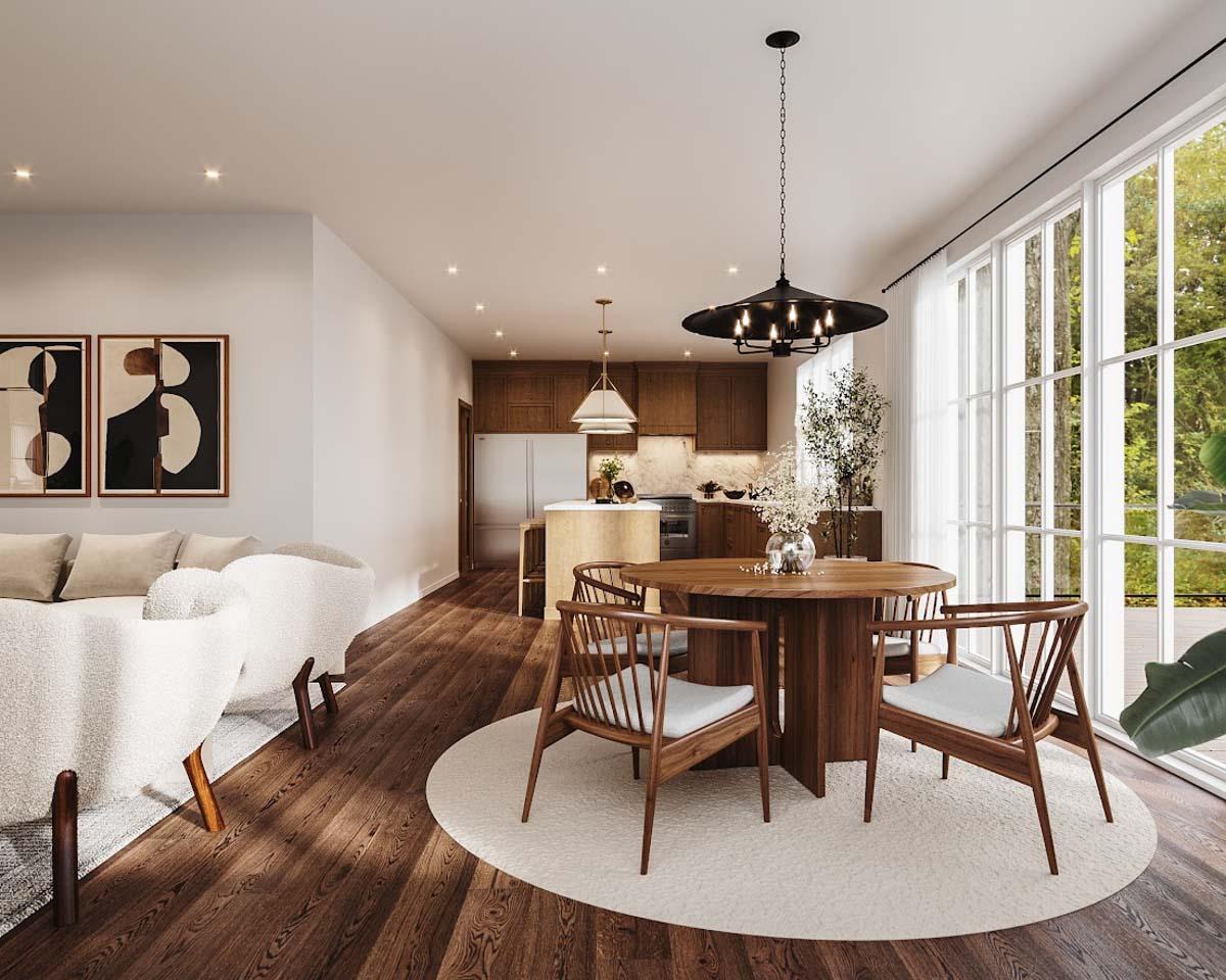 Interior of a modern living space with dining area, kitchen, and large windows. Includes round table and chairs, hardwood floors.