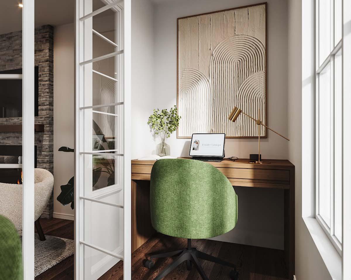 Cozy home office with a wooden desk, green chair, abstract artwork, and natural light.