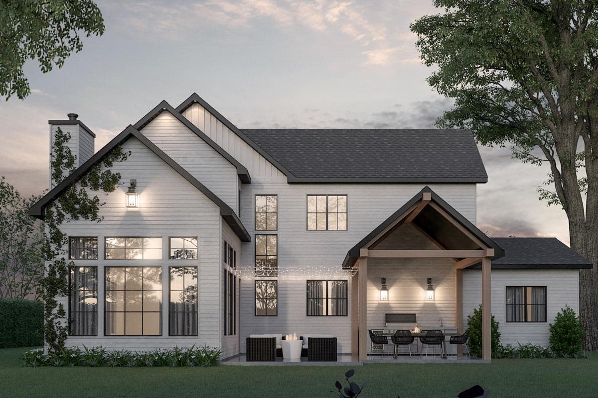 Modern Farmhouse house plan exterior with a gable roof, white siding, large windows, and a covered outdoor kitchen area.
