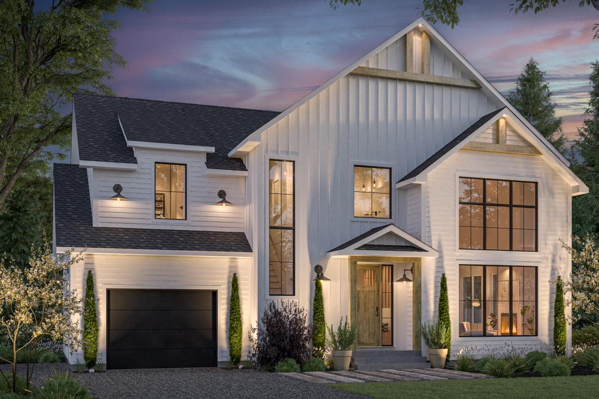 A modern white farmhouse with black trim windows, a black garage door, and a welcoming front entrance. The house is illuminated at dusk.