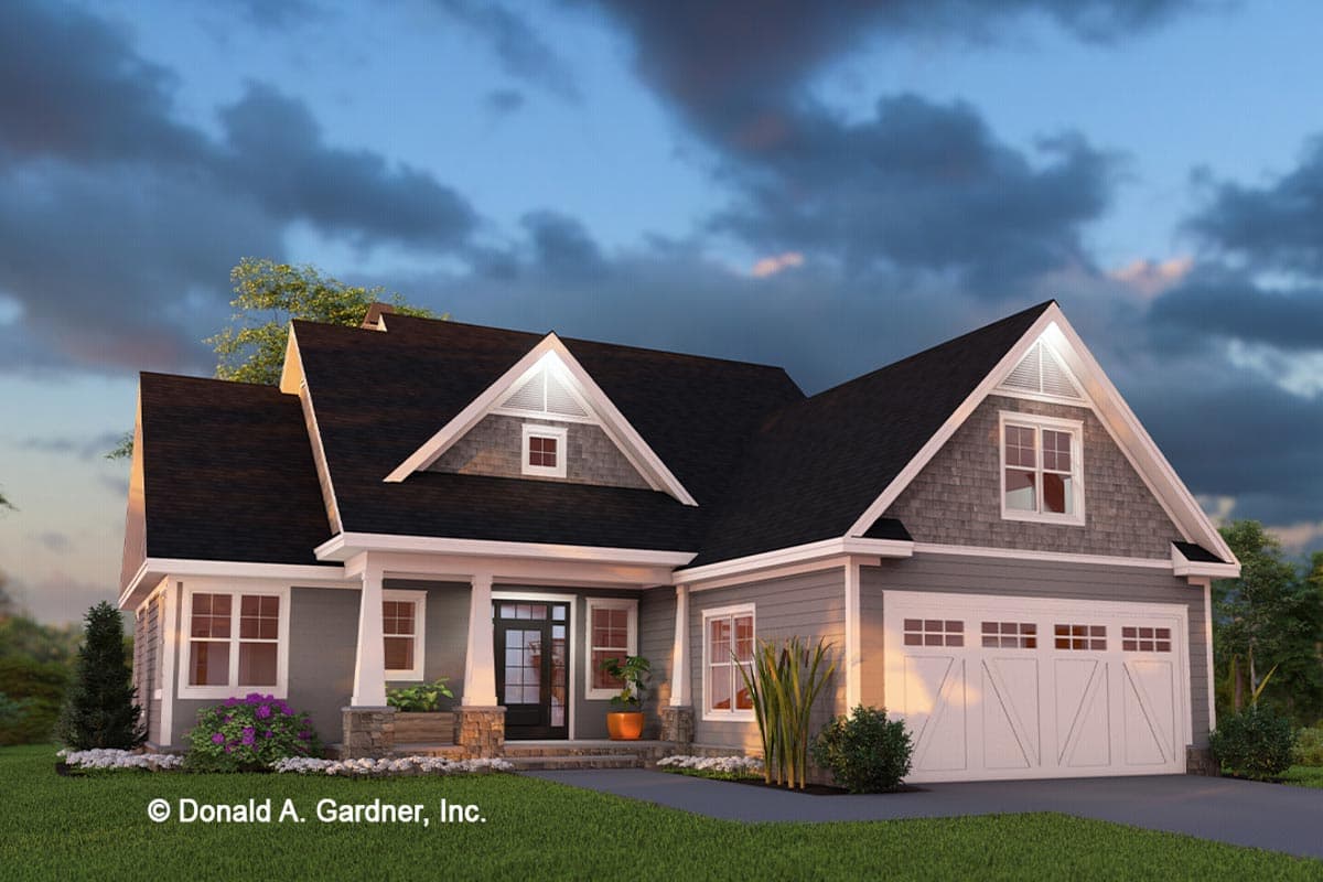 House plan exterior featuring a Craftsman style. The one-story home has a front porch, gables, and a garage with a carriage-style door.