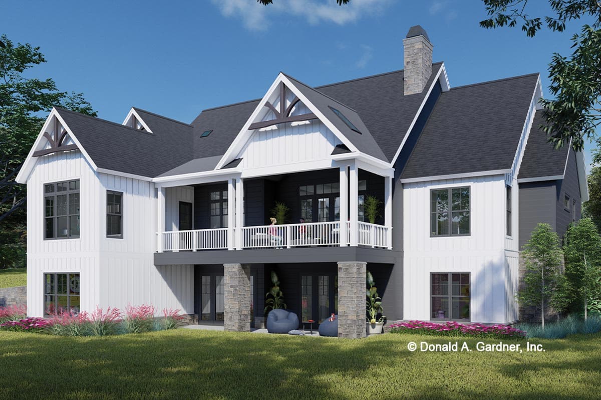 House plan exterior, modern farmhouse style, two stories, with upper balcony, stone-clad columns, and decorative gable trusses.