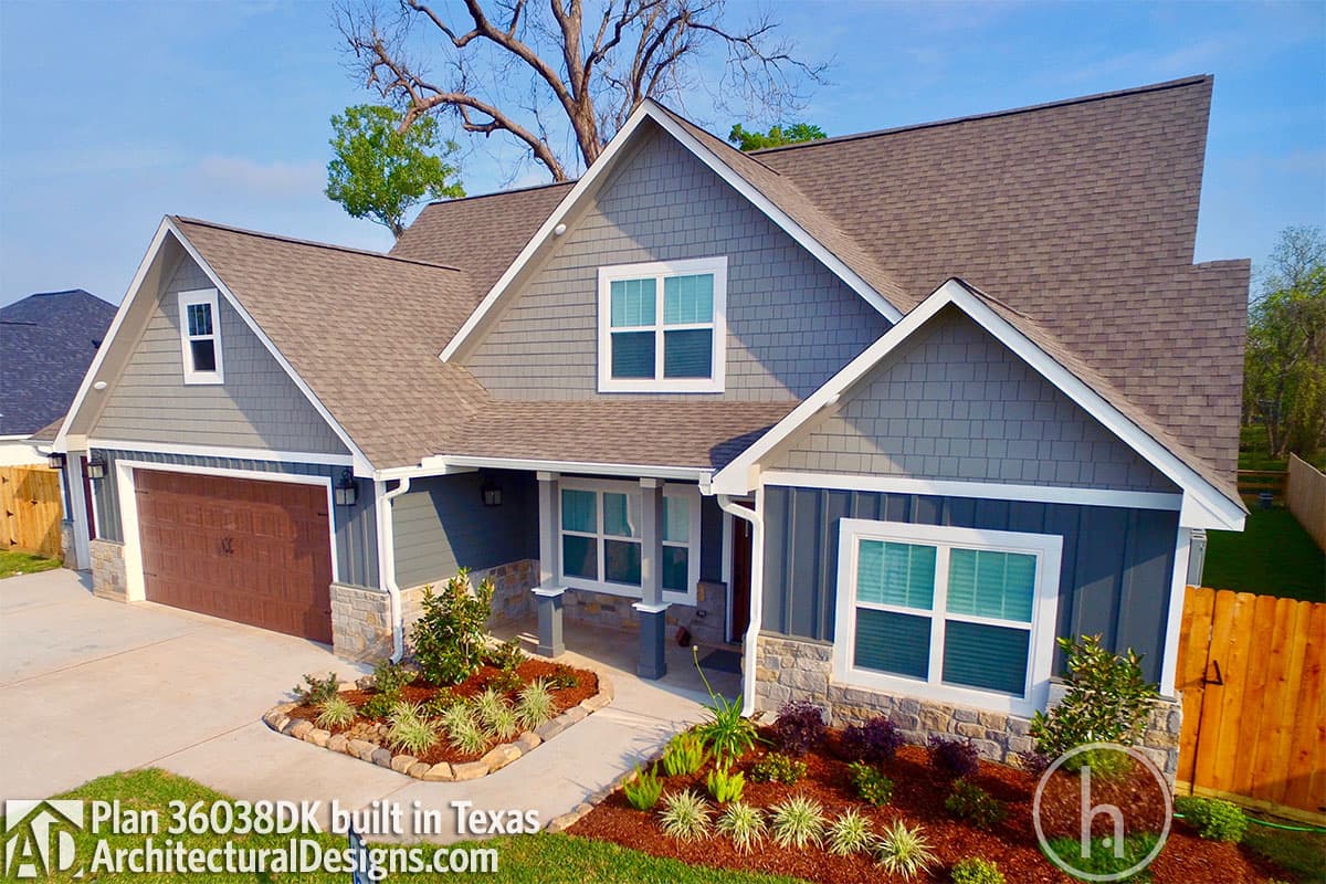 House plan exterior: Ranch style, one story, with a gabled dormer, covered entry porch, and side-facing garage.