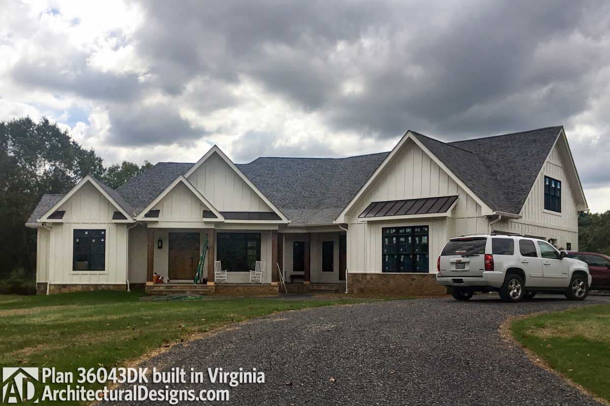 Modern Farmhouse style house plan exterior with board and batten siding, gables, and metal roof overhangs.
