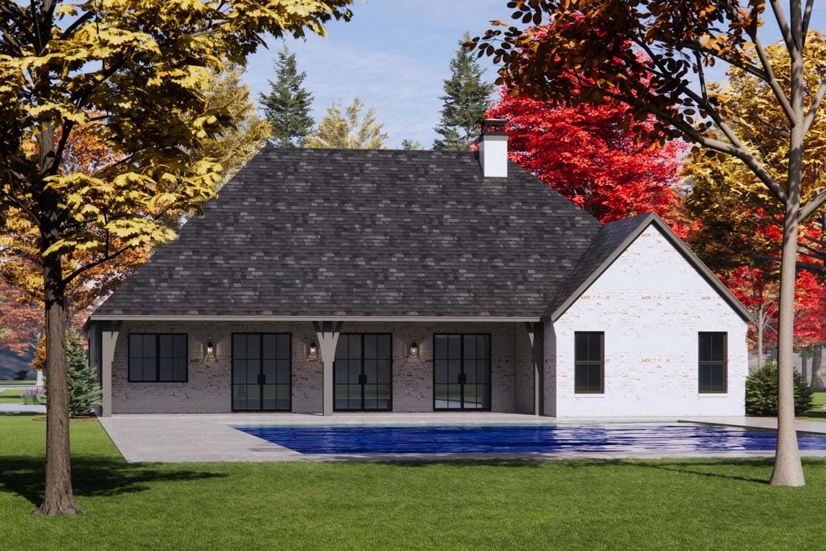 House plan exterior: Ranch style, single-story home with a gabled roof, brick facade, covered patio, and large glass doors.