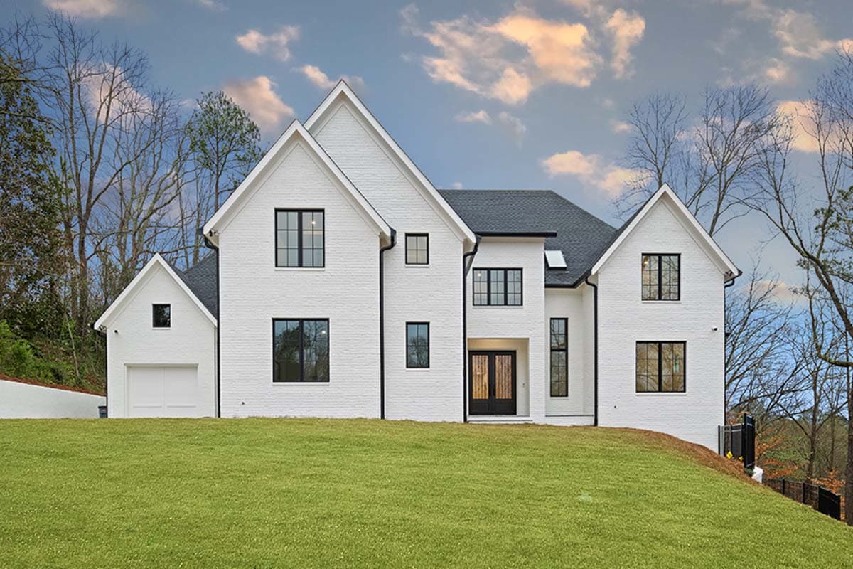 Modern Farmhouse house plan exterior with white brick, gables, black windows, and a side-entry garage.