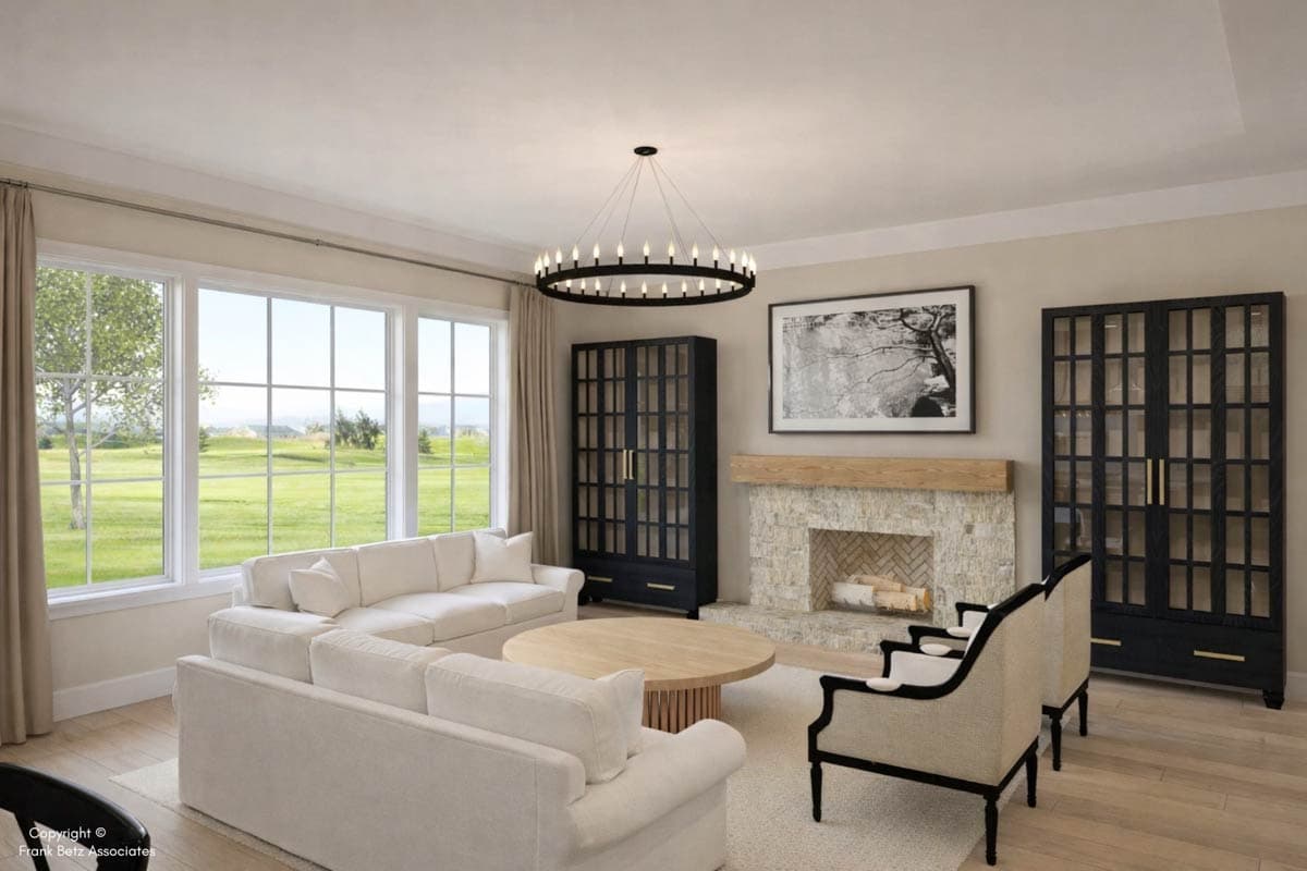 Living room with large windows, fireplace, two dark cabinets, round coffee table, and sectional sofa.
