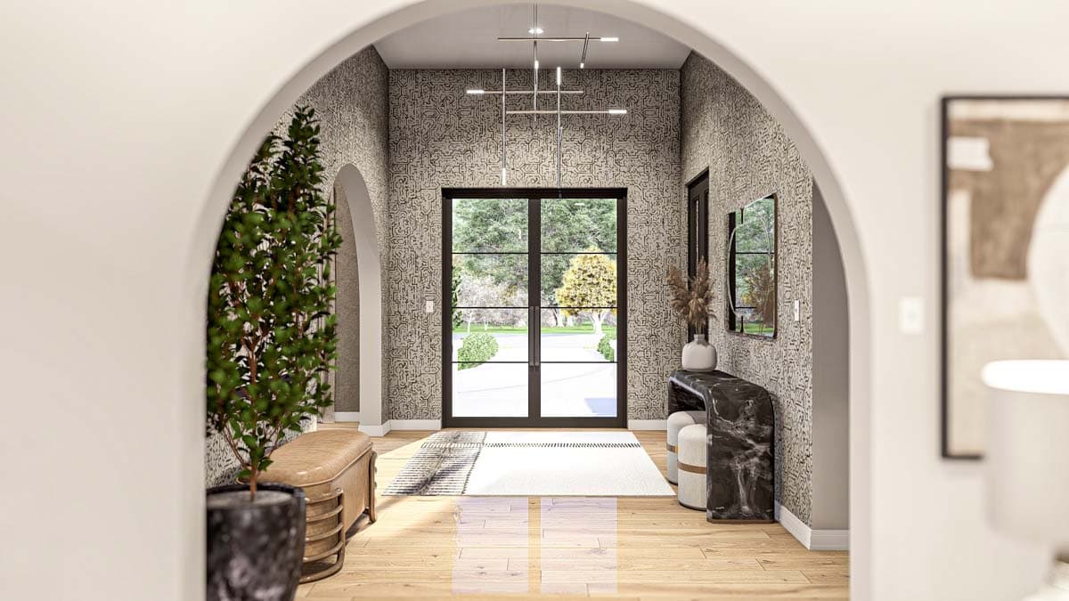 Entryway with double doors, patterned wallpaper, modern chandelier, console table, and seating.