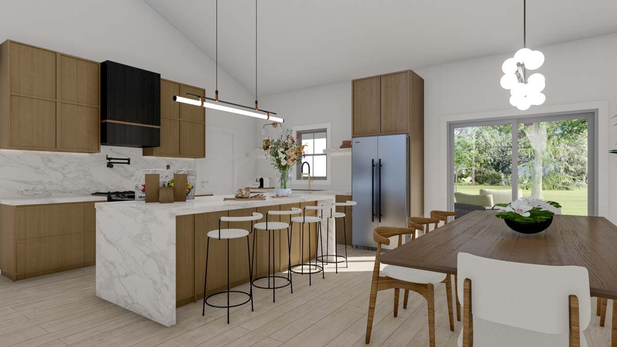 Open concept kitchen and dining area with vaulted ceiling, large island with seating, and modern cabinetry.