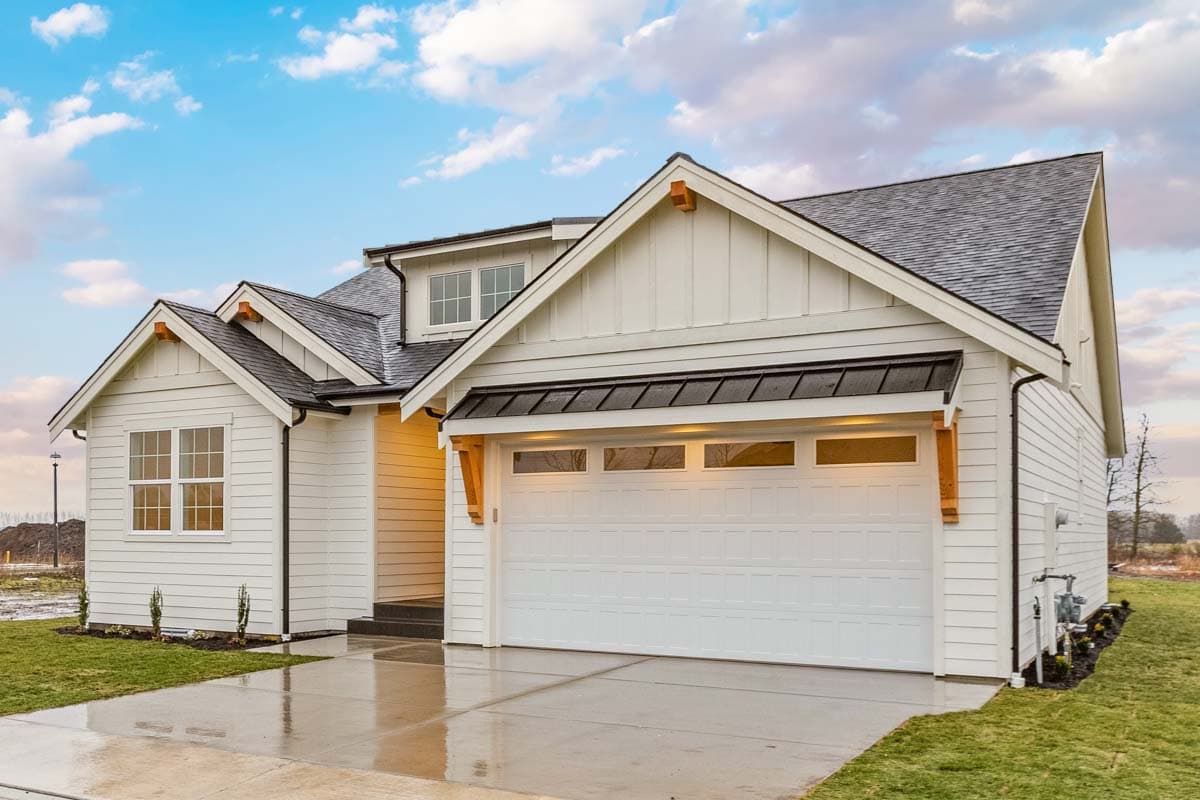 Modern Farmhouse house plan exterior with white siding, gabled rooflines, dormer, and attached garage.