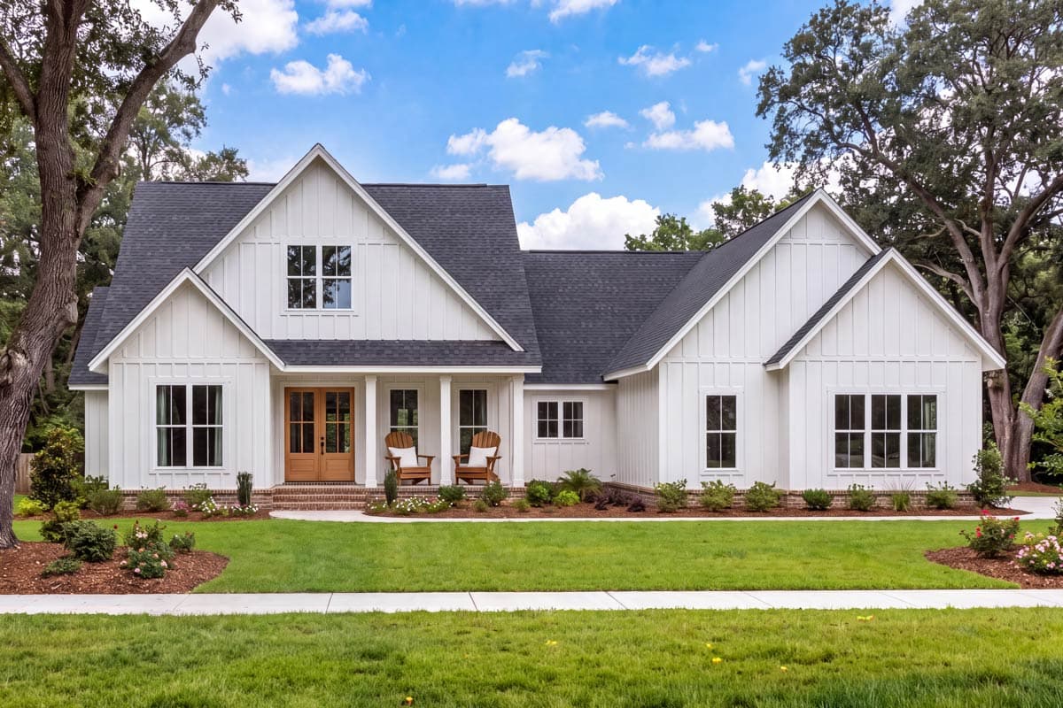 House plan exterior. Modern Farmhouse style with board-and-batten siding, multiple gables, and a front porch. Two-story with dark framed windows.