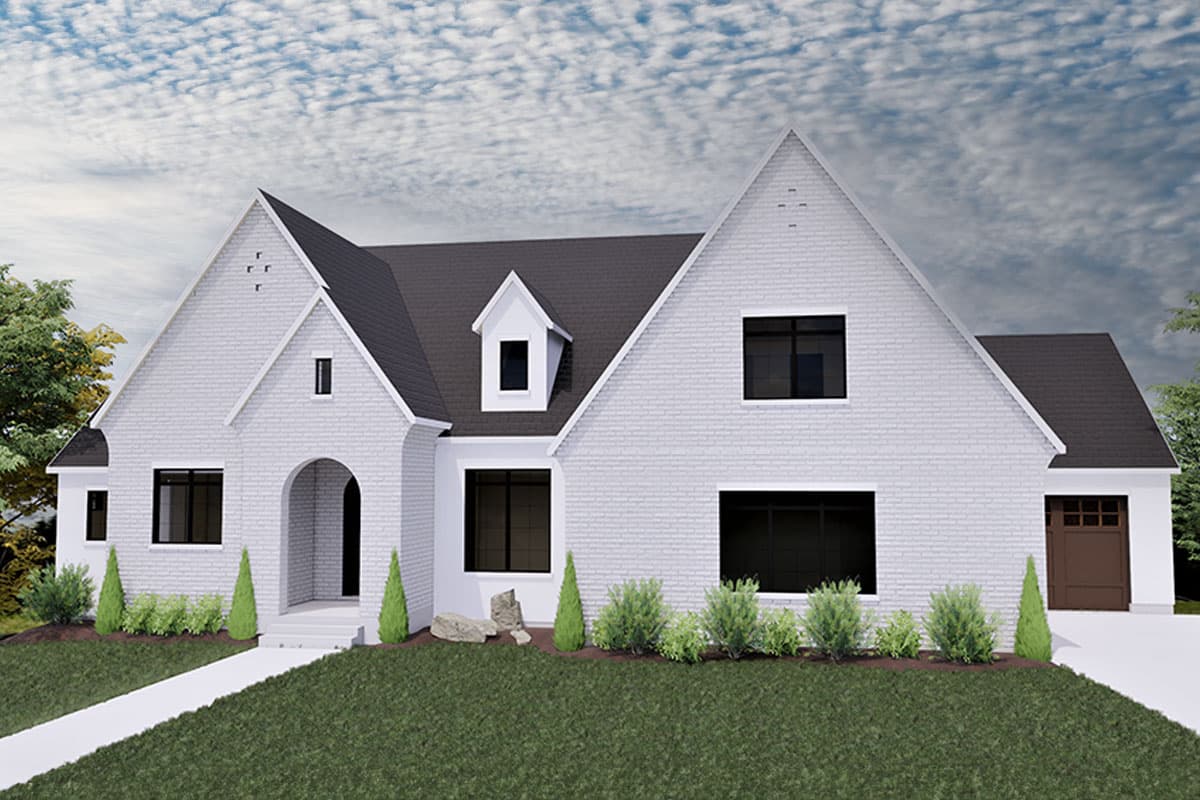 House plan exterior. Two-story home with gabled roof, dormer, and an arched entry. Features include a front-facing garage.