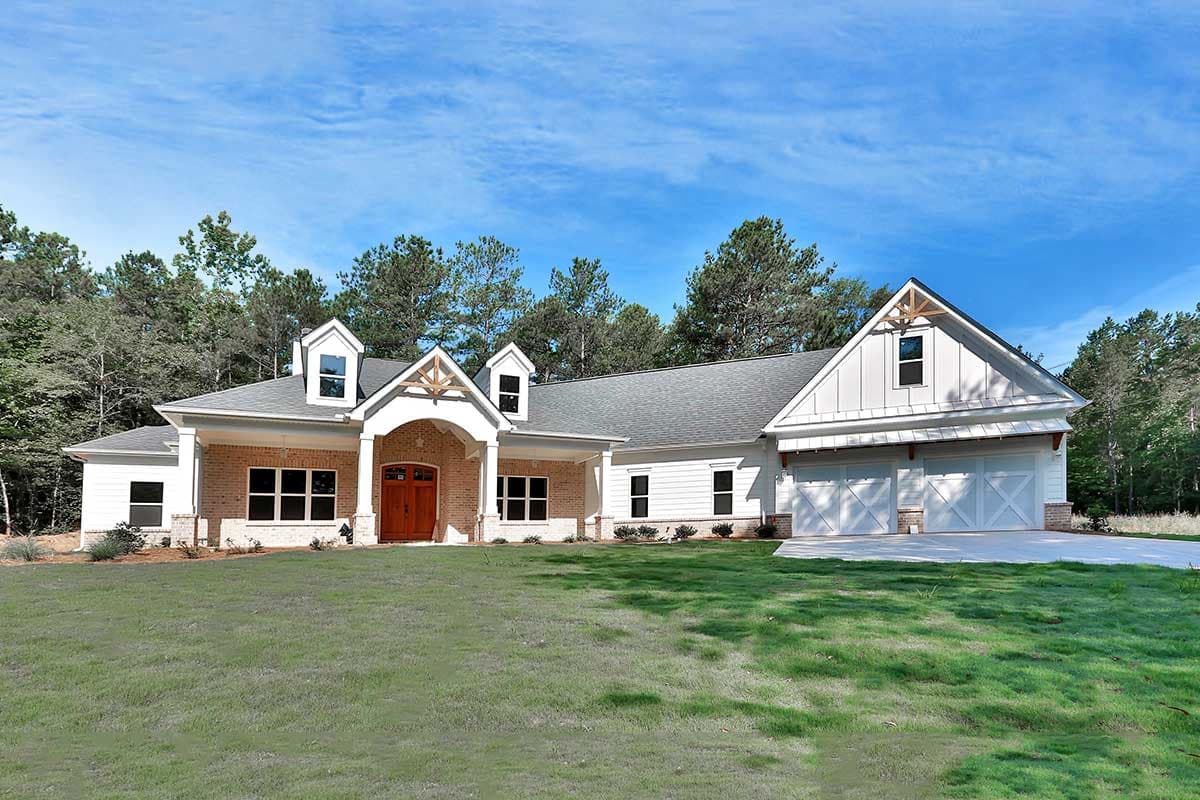 House plan exterior featuring a two-story farmhouse style with a front porch, gables with dormers, and a two-car garage.