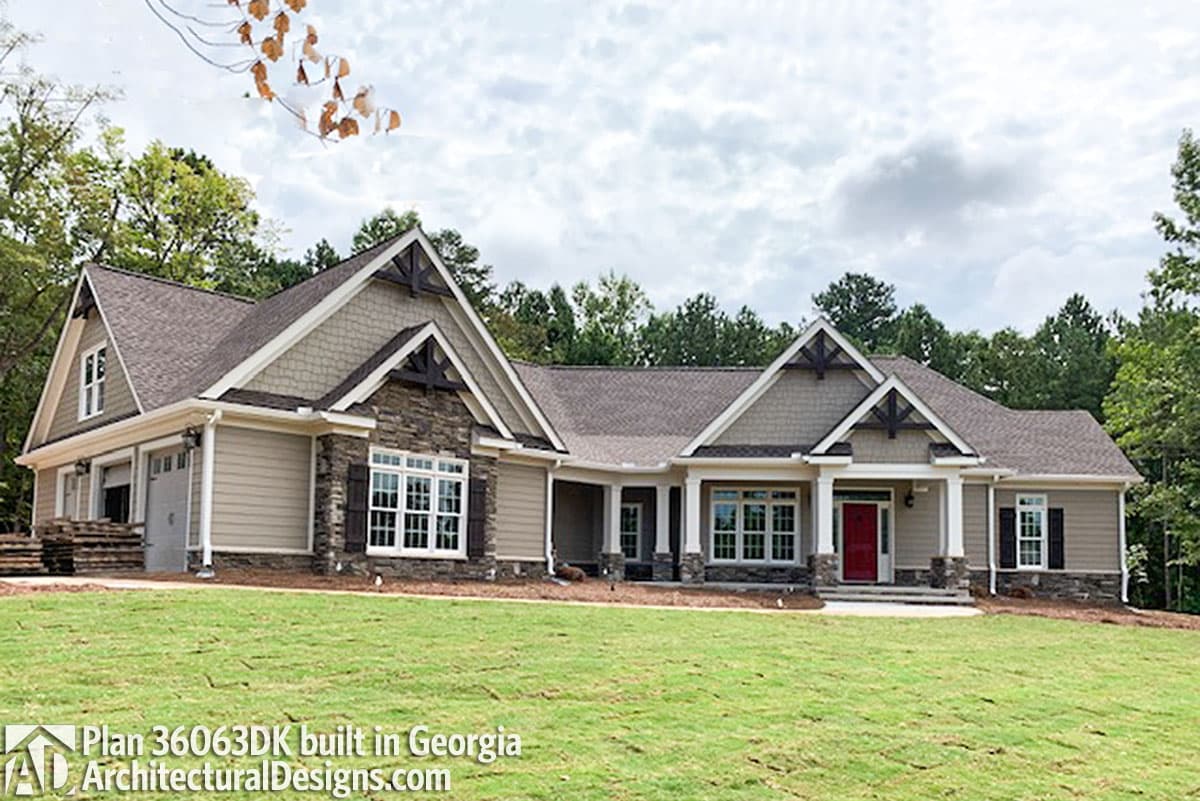 House plan exterior: Craftsman style, one-story with stone accents, prominent gables, and a covered front porch.