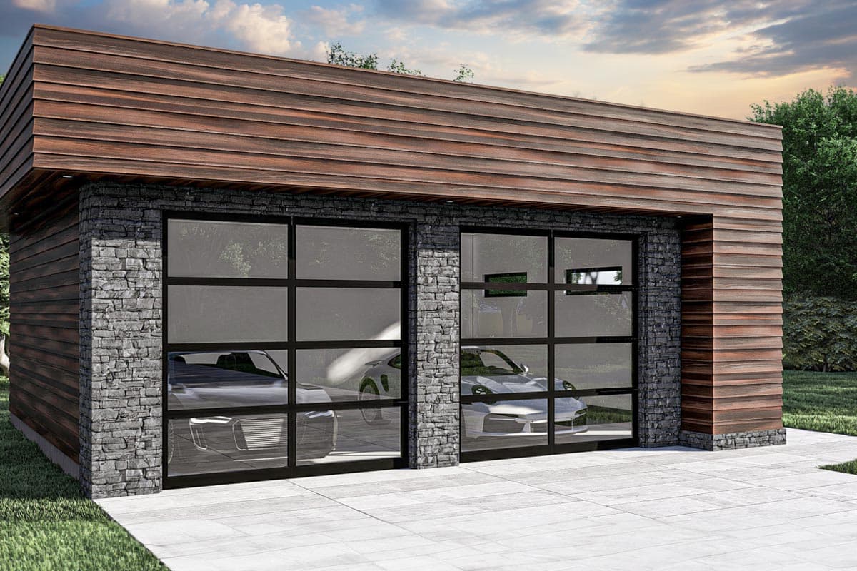Modern garage exterior with stacked stone, wood siding, and two glass sectional doors revealing cars.