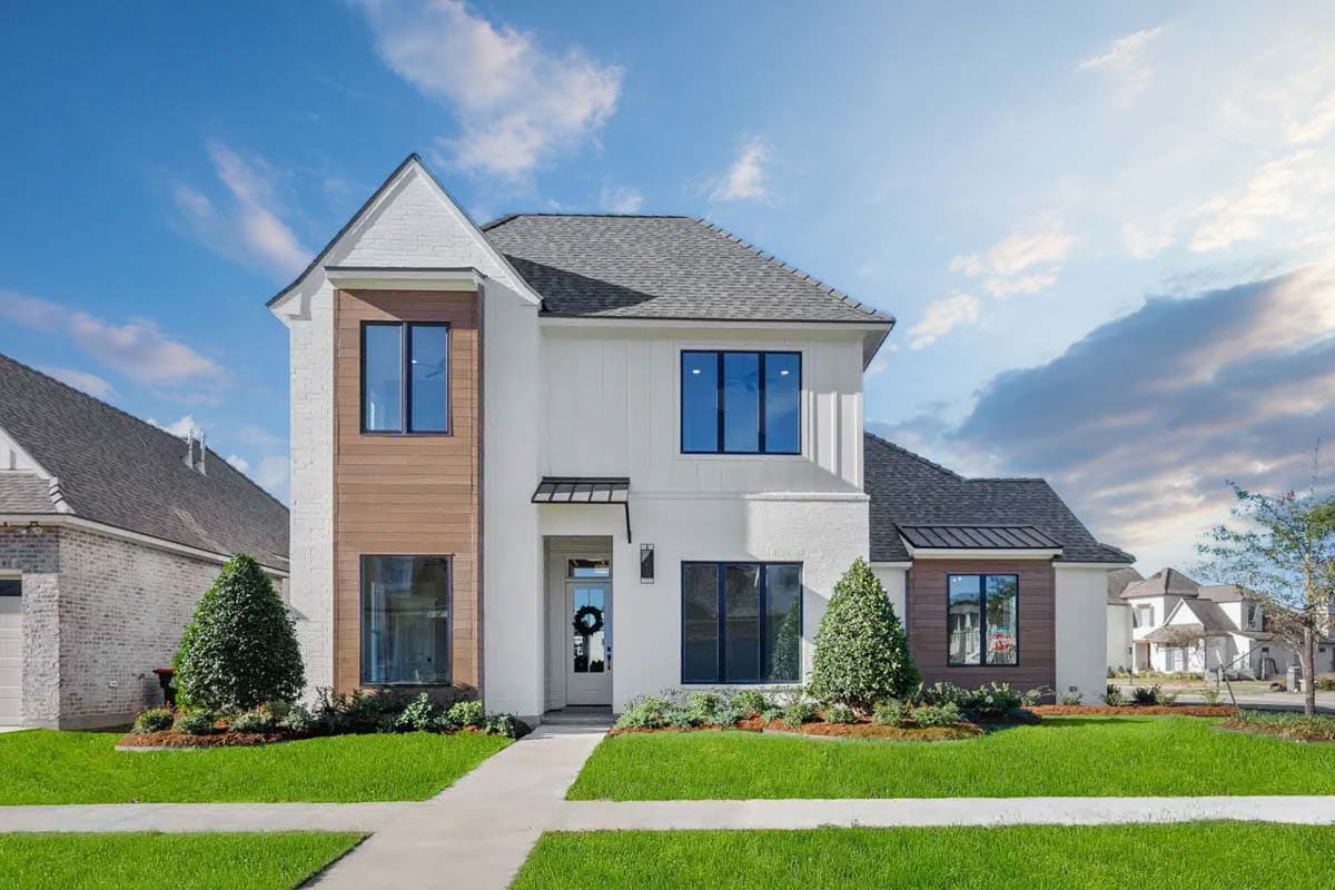 House plan exterior. Two-story modern farmhouse with gabled roof, mixed siding, and dark-framed windows. Features a covered entry and wood accents.