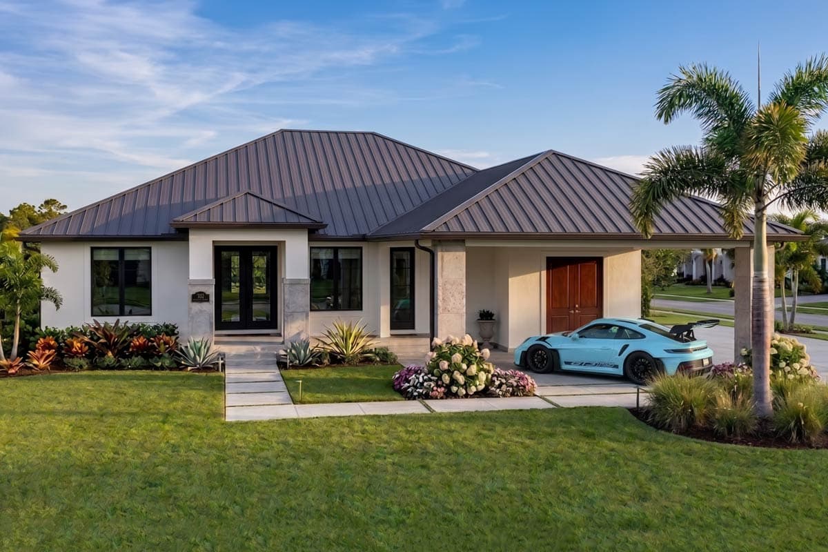 One-story house plan exterior with metal roof, double front doors, large windows, and attached garage. Modern style.