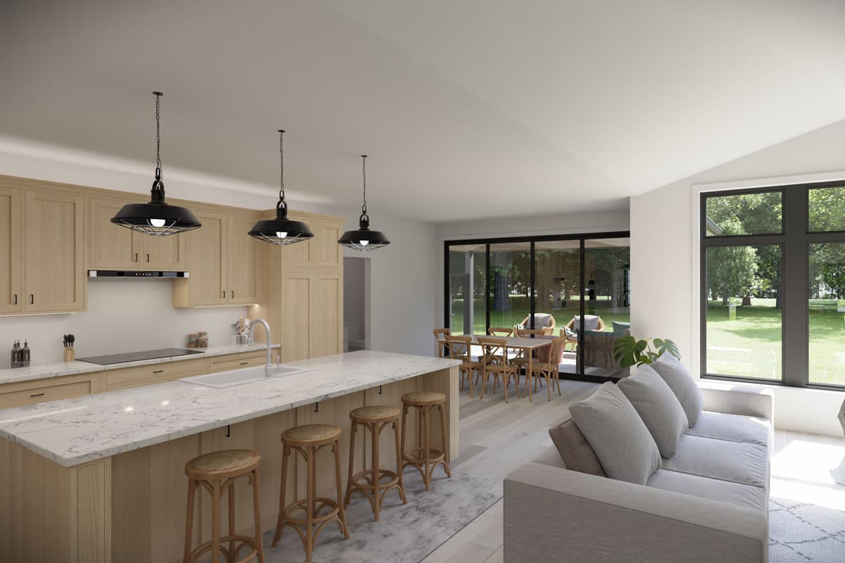 Open-concept living area featuring a kitchen with a large island and wood cabinetry, dining area, and living room with a sofa and large windows.