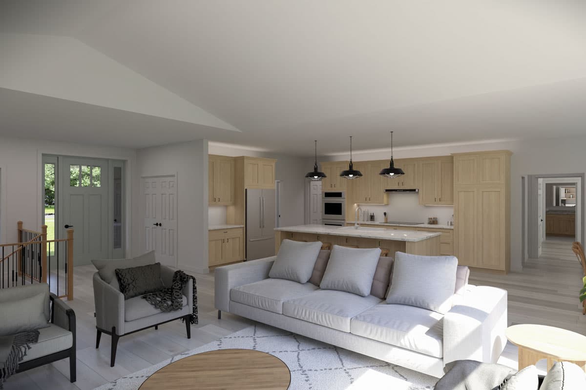 Open concept living area with vaulted ceiling, island kitchen, and entry foyer.