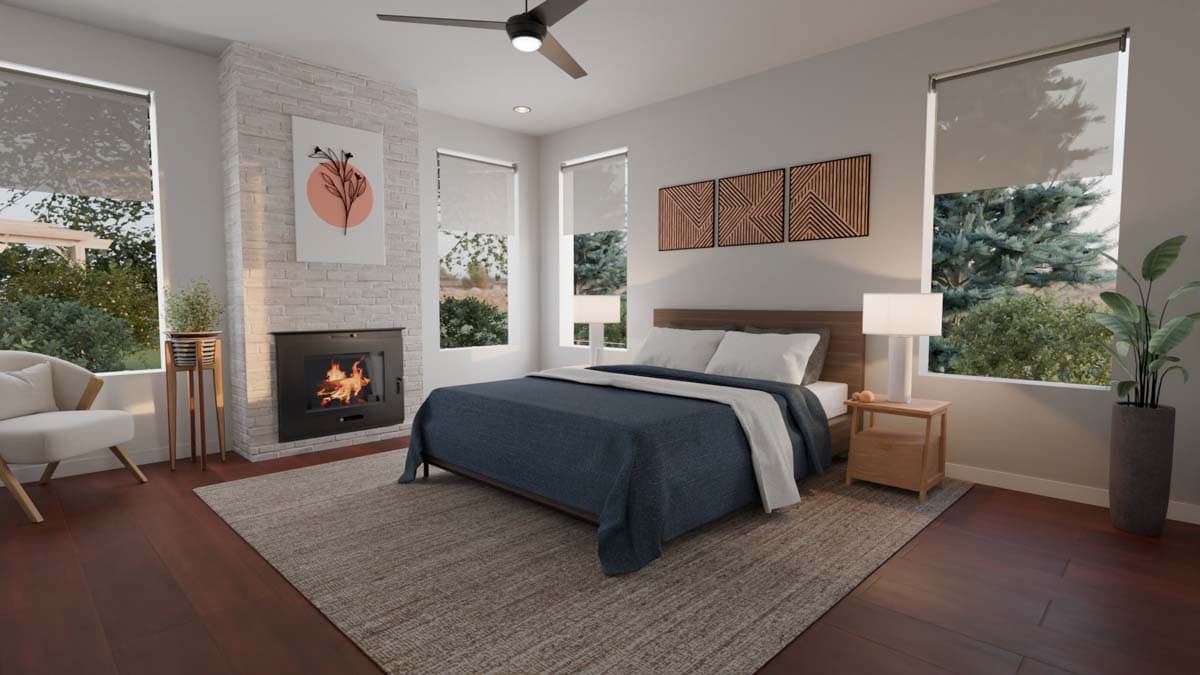 Bedroom interior with wood-burning fireplace, king bed, and large windows overlooking trees.